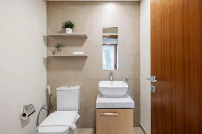 a bathroom with a toilet and a sink at 1BR with Study City View Bay Square in Dubai