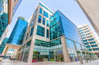 a tall building with glass windows in a city at 1BR with Study City View Bay Square in Dubai
