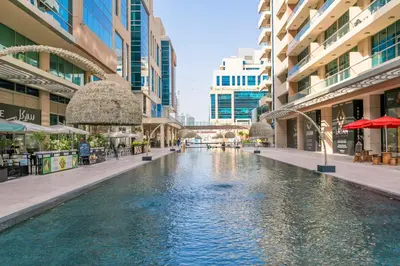 a pool in the middle of a city with buildings at 1BR with Study City View Bay Square in Dubai