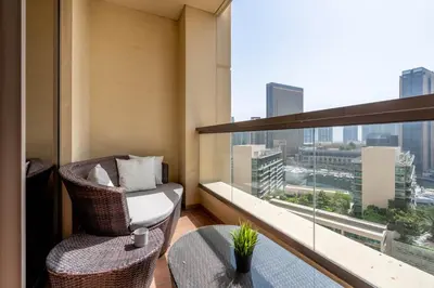 a balcony with a chair and a table and a window at GuestReady - Marvellous getaway in Dubai Marina in Dubai