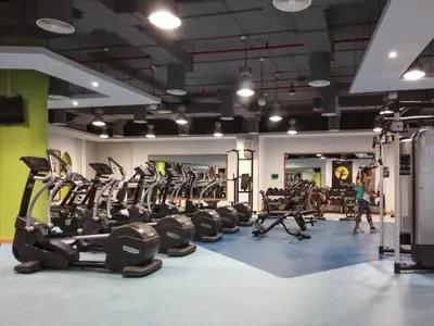 a gym with tread machines and people walking in it at GuestReady - Marvellous getaway in Dubai Marina in Dubai