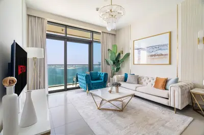 a living room with a couch and a table at GuestReady - Blue Diamond Beachfront Retreat in Dubai