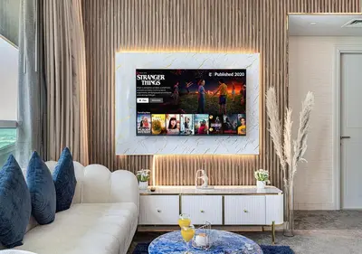 a living room with a couch and a tv at Burj Khalifa View! 2 Bedroom Luxe Apartment with 4 minute walk to Dubai Mall! Pool and Sauna Access! in Dubai