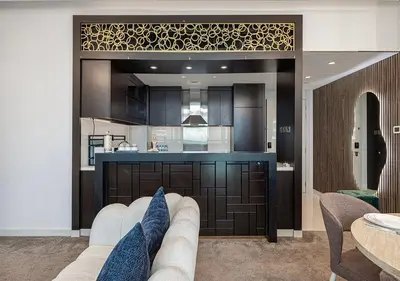 a living room with a couch and a kitchen at Burj Khalifa View! 2 Bedroom Luxe Apartment with 4 minute walk to Dubai Mall! Pool and Sauna Access! in Dubai