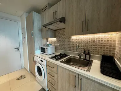 a kitchen with a sink and a microwave at Hight-floor Studio Atlantis view in Dubai