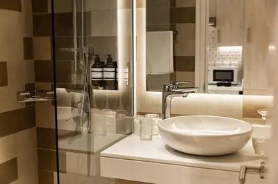 a bathroom with a sink and a glass shower at Hight-floor Studio Atlantis view in Dubai