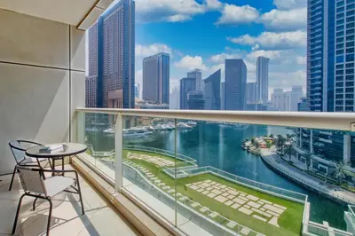 a balcony with a view of the water in a city at ShoresInn - Serene Retreat with Waterfront Views in Dubai