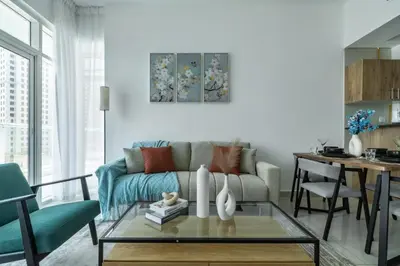 a living room with a couch and a table at ShoresInn - Serene Retreat with Waterfront Views in Dubai
