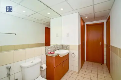 a bathroom with a toilet and a sink at Luxury Escapes - Spacious 1BR with Pool view - Ghozlan 2 The Greens in Dubai