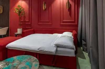 a red bedroom with a bed and a table at 5 Star Apartment with Burj View Infinity Pool and Gym Spa in Dubai