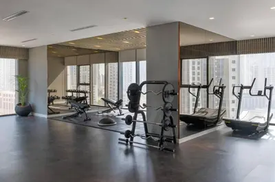 a gym with treadmills and cardio equipment in a building at 5 Star Apartment with Burj View Infinity Pool and Gym Spa in Dubai