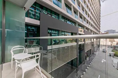 a balcony with a white chair on a building at Modern and Cozy Studio at Seven Palm Prime Location in Dubai