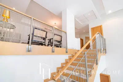 a view of a staircase in a house at LUX The Shoreline Palm Island Penthouse in Dubai