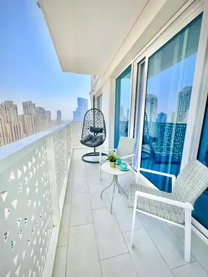 a balcony with chairs and a table on a building at La Vie Beach front JBR apartment by Happy Season in Dubai