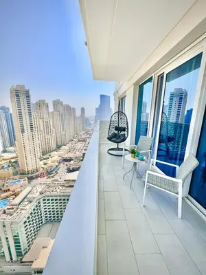 a balcony with chairs and a view of a city at La Vie Beach front JBR apartment by Happy Season in Dubai