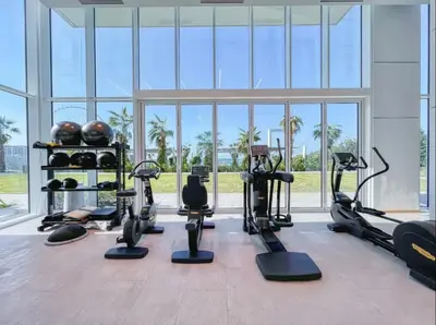 a gym with treadmills and exercise equipment in a building at La Vie Beach front JBR apartment by Happy Season in Dubai