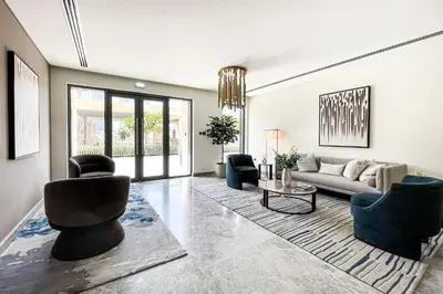 a living room with a couch and chairs and a table at 1BR Burj Royale Near Dubai Mall Downtown in Dubai