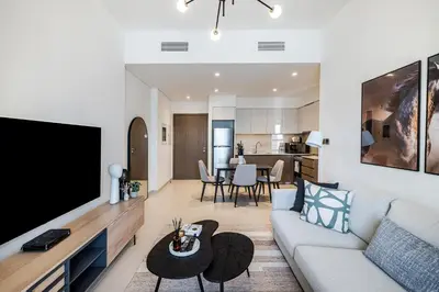 a living room with a couch and a flat screen tv at 1BR Burj Royale Near Dubai Mall Downtown in Dubai