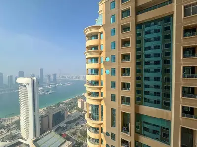a tall building with a view of a city at Vibrant 1 Bedroom at Barasti-Dubai Marina in Dubai