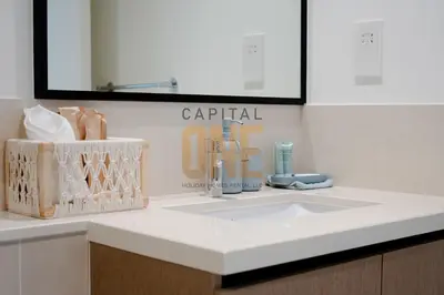 a bathroom counter with a sink and a mirror at Burj Khalifa View, Pool, Parking, 1BR, Downtown Dubai, Modern Furnished in Dubai