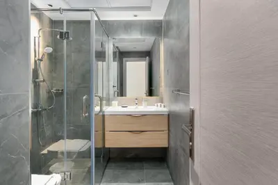 a bathroom with a sink and a glass shower at Vacay Lettings - Spacious 3 Bedroom at JBR walk in Dubai