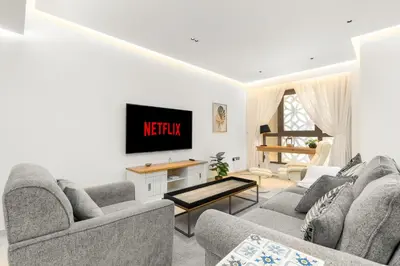 a living room with two couches and a tv at Vacay Lettings - Spacious 3 Bedroom at JBR walk in Dubai