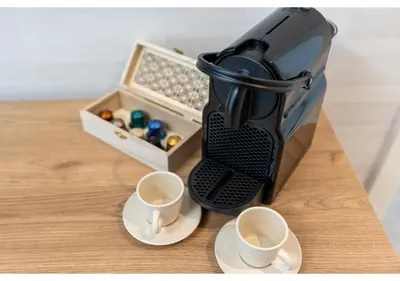 a coffee maker sitting on a table with two cups at Trendy & Cozy 1BR Midtown 20 mins to Expo City by Vibel in Dubai