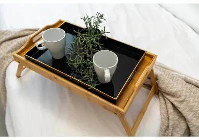 a tray with two cups and a plant on a bed at Trendy & Cozy 1BR Midtown 20 mins to Expo City by Vibel in Dubai