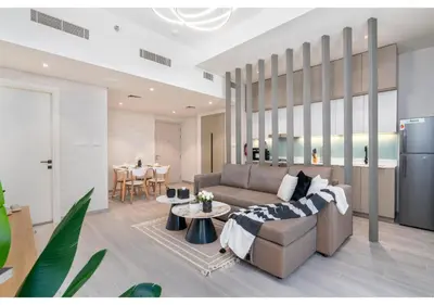 a living room with a couch and a table at Trendy & Cozy 1BR Midtown 20 mins to Expo City by Vibel in Dubai