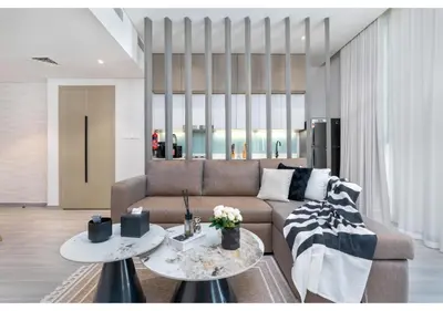 a living room with a couch and two tables at Trendy & Cozy 1BR Midtown 20 mins to Expo City by Vibel in Dubai