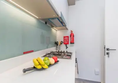 a kitchen with a stove with fruits on the counter at Classy 1BR in Midtown Access All Dubai Spots by Vibel in Dubai
