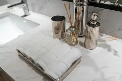 a white towel on a counter next to a sink at Stylish 1BR w City Views Palace Creek Harbour by Vibel in Dubai