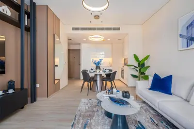 a living room with a white couch and a table at Stylish 1BR w City Views Palace Creek Harbour by Vibel in Dubai