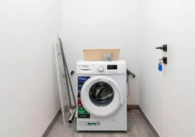 a washer and dryer in a laundry room at Cozy 2BR Near Dubai Spots Midtown Dubai Access by Vibel in Dubai