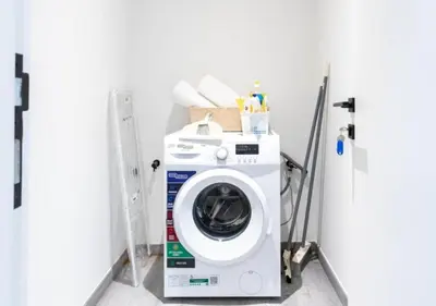 a washer and dryer in a laundry room at Cozy 2BR Near Dubai Spots Midtown Dubai Access by Vibel in Dubai
