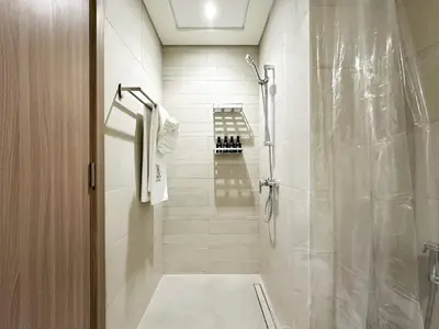 a bathroom with a shower with a glass door at Trophy Blissful Bend Studio in Meydan with Pool Views in Dubai