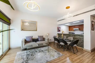 a living room with a couch and a table at 1BR The Greens Courtyard View in Dubai