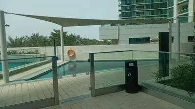 a swimming pool with a trash can next to a building at Luxury at JBR Jumeirah Gate Tower 1 1 Bed in Dubai