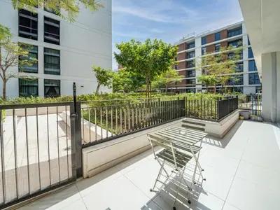 a balcony with a chair and a fence at Dubai Hills Elegant 1-Bed with Terrace in Dubai