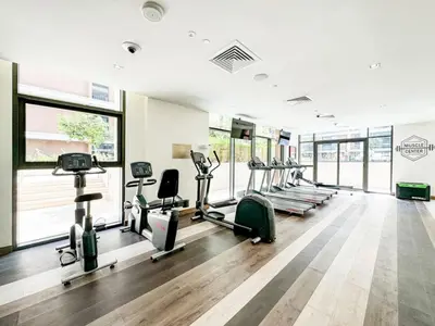 a gym with several treadmills and elliptical machines at Dubai Hills Elegant 1-Bed with Terrace in Dubai
