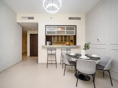 a kitchen and dining room with a table and chairs at Downtown 1 Bed - Burj Khalifa Balcony View in Dubai