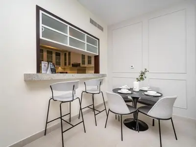 a dining room with a table and four chairs at Downtown 1 Bed - Burj Khalifa Balcony View in Dubai