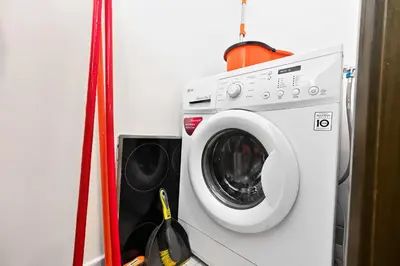 a washing machine in a room with a red at Prime Downtown Burj Khalifa I Sleeps 8 in Dubai