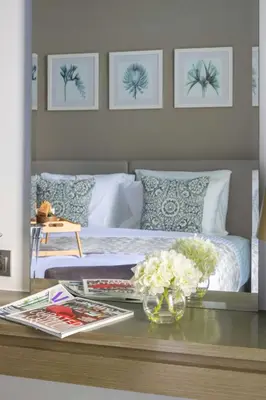 a bedroom with a bed and a table with flowers at Frank Porter - Damac Maison Prive B in Dubai