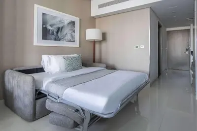 a hospital room with a bed and a chair at Frank Porter - Damac Maison Prive B in Dubai