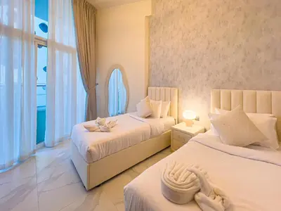 a bedroom with two beds and a window at Millennium Binghatti Residence 2BR Burj Khalifa and Lake in Dubai