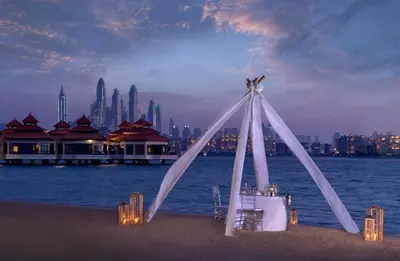 a white tent on the beach with a city at Luxury Holiday Home, Spacious 1 bedroom, Burj Alarab full ocean view, located in Anantara the palm, Palm Jumeirah, Dubai in Dubai