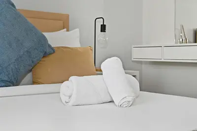 a pile of towels sitting on top of a bed at Brand new Business Bay location in Dubai