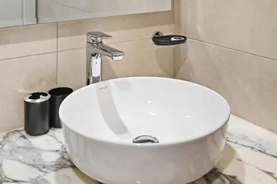 a bathroom with a white sink on a marble counter at Brand new Business Bay location in Dubai