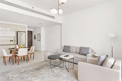 a living room with a couch and a table at Silkhaus Marina View 1BDR Marina Vista Tower in Dubai